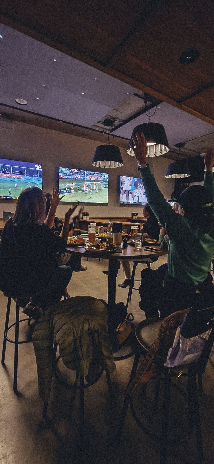 Members cheering together at a pop-up event